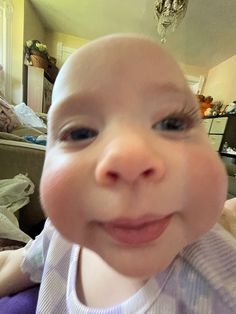 a close up of a baby smiling at the camera