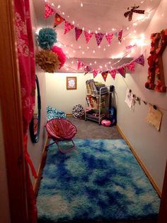 a room with some lights and decorations on the ceiling, carpeted in blue and pink