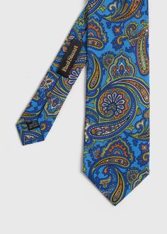 Paul Stuart neckties are made from the finest fabrics in intricate paisleys, florals and vintage prints. This bright paisley print tie adds a bold pop of color and pattern to your summer suit.   Self Tipped Italian Printed Silk Made in Italy 9 cm. Paul Stuart is one of the oldest and most well respected names in fashion, offering exclusive and custom tailored clothing, sportswear, footwear and accessories for men and women. Renowned for expert craftsmanship, thoughtful design using materials and Classic Fitted Multicolor Ties, Multicolor Paisley Print Suit And Tie Accessories For Business, Elegant Multicolor Paisley Print Ties, Classic Floral Print Ties For Summer, Classic Floral Print Summer Tie, Elegant Patterned Summer Ties, Elegant Summer Patterned Ties, Classic Paisley Print Patterned Ties, Summer Suit