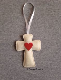 a cross ornament with a heart on it