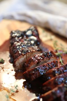 grilled meat sitting on top of a wooden cutting board