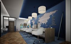 an office with blue and white walls, wood flooring and large world map on the wall