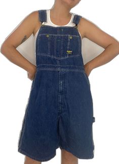 Utility Denim Shortalls With Side Pockets, Utility Style Dark Wash Shortalls With Pockets, Utility Style Dark Wash Cotton Overalls, Medium Wash Shortalls With Pockets, Denim Shortalls With Pockets In Dark Wash, Denim Shortalls With Pockets And Bib Front, Utility Dark Wash Shortalls With Pockets, Dark Wash Denim Shortalls With Pockets, Utility Bib Front Bottoms In Dark Wash