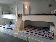 bunk beds in a room with stairs leading up to the top bed and another set of drawers below them