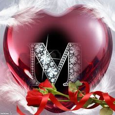 a red heart with the letter m on it and a rose in front of it