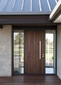 the front door to a modern home with wood flooring