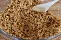 a glass bowl filled with brown sugar and a wooden spoon in the bottom right corner