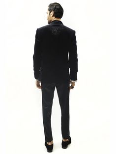 Astrum handcrafted tuxedo is highlighted with metallic threads. Single-buttoned satin detail shawl collar. This creation in velvet can be tempered with flat-front trousers for a reception look. Tailored Tuxedo Sets For Gala, Luxury Festive Tuxedo For Gala, Tailored Tuxedo For Gala Festivities, Tailored Tuxedo For Gala And Festive Occasions, Velvet Tuxedo For Winter Party, Winter Velvet Tuxedo With Notch Lapel, Tailored Festive Tuxedo For Gala, Festive Tuxedo Suit For Gala, Winter Velvet Tuxedo For Semi-formal Occasions