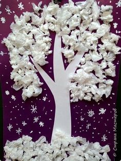 a paper cut out of a tree with snowflakes on it