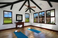 a room with yoga mats and windows in it