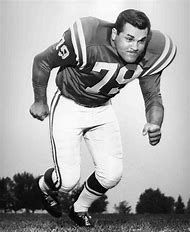 an old black and white photo of a football player