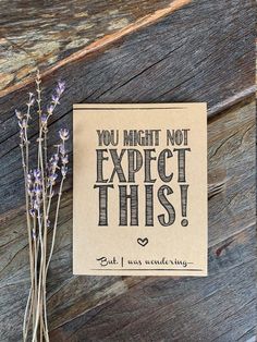 a card that says you might not expect this next to some lavenders on a wooden surface