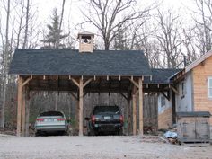 two cars parked in front of a wooden building