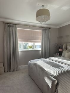 a bed sitting under a window in a bedroom