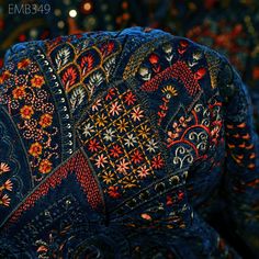 the back of an elephant's head is decorated with colorful flowers and paisleys