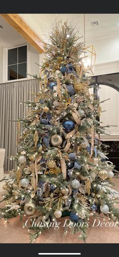 a christmas tree decorated with blue and gold ornaments