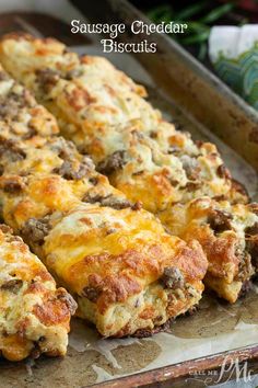 sausage cheddar biscuits on a baking sheet