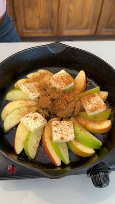 an iron skillet with apples and cinnamon in it