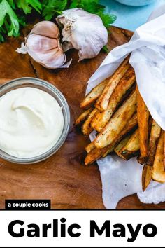 garlic mayo on a cutting board next to some french fries and fresh herbs with text overlay that reads garlic mayo