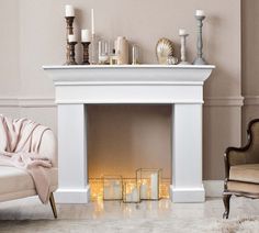 a living room with a fire place and candles