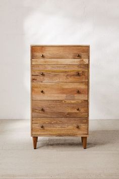 a wooden dresser sitting on top of a white floor