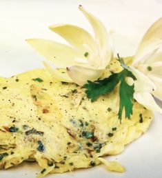 an omelet with some flowers on top of it