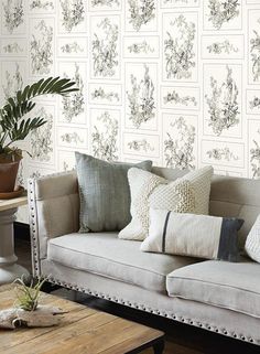 a living room filled with furniture and wallpaper