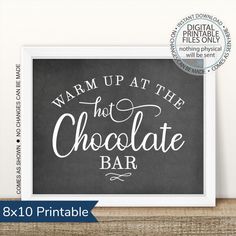 a chalkboard sign with the words warm up at the hot chocolate bar on it