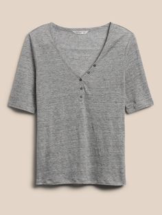 Equally suited to the weekly grind or weekend brunch, this casual linen henley is crafted from linen that stays cool and fresh in luxurious style.  SEMI-FITTED: Cut for a not-too-tight, not-too-loose fit.  V-neck with button placket.  Straight hem. Casual Spring Henley For Everyday Wear, Spring Casual Henley With Button Closure, Summer Henley With Button Closure, Spring Relaxed Fit Henley With Button Closure, Summer Everyday Henley With Button Closure, Summer Henley With Buttons, Summer Cotton Henley With Buttons, Gray Linen Tops For Fall, Spring Relaxed Fit Henley For Everyday