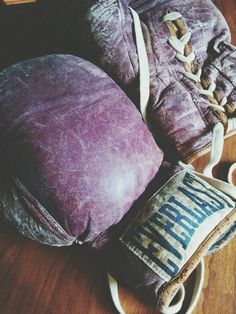 a pair of mitts and pillow on the floor next to a bag with an inscription written on it