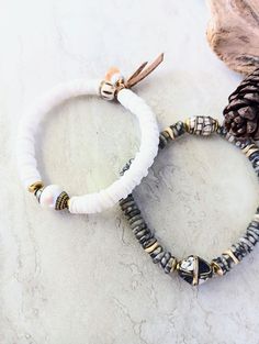 "Earthy, serene, timeless, and beachy. Beautiful black, beige, gray, matte gold, and ecru in these natural bracelets. Black and white handmade Tibetan Trade beads, Pearl Trade bead, Golden Jade, Silver Leaf Jasper disks, shell disks. Etched bone bead, suede tie, and metal accents. Unique and stunning. Your new favorite bracelets. Bracelets is 7.0\" to 7.5\" in length. HavSolStudio on ETSY | Mixed media . Earthy elegance . Great texture . Beach inspired . Coastal calm . A little rustic . Worldly White Heishi Beads Bohemian Stretch Bracelet, Bohemian White Heishi Beads Stretch Bracelet, White Hand-strung Bracelets For Vacation, Hand-strung White Bracelets For Vacation, White Hand-strung Bracelet For Vacation, Elegant White Stretch Bracelet For Beach, Cream Round Beads Bracelets For Beach, Cream Bracelets With Round Beads For Beach, Bohemian White Bracelets For Everyday