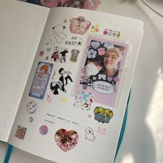 an open book with stickers and pictures on it