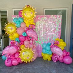 balloons are arranged in the shape of flamingos and sunflowers for a 21st birthday party