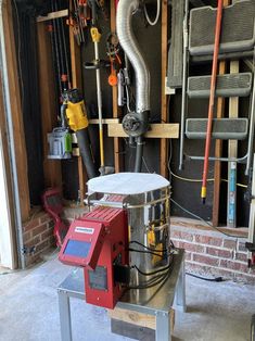 a machine that is sitting in the middle of a room with pipes and tools on it