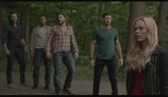 a group of young people walking down a path in the woods with trees behind them