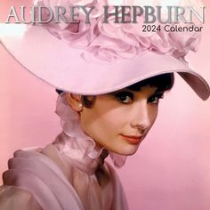 a woman wearing a pink hat with flowers on it's brimmed top