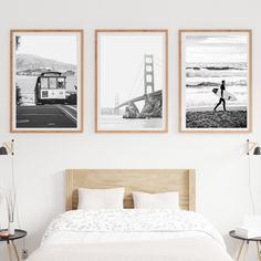 three black and white photographs hang above a bed