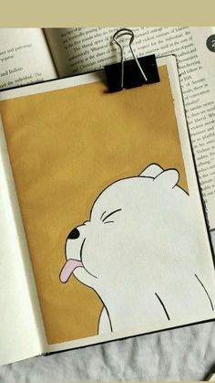 an open book with a drawing of a polar bear sticking its tongue out on the pages