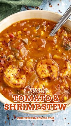 a white bowl filled with shrimp and corn soup on top of a blue table cloth