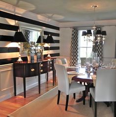 a dining room with black and white striped walls