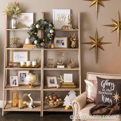 a living room filled with christmas decorations and gold stars on the wall above it is a shelving unit