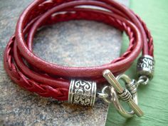 A Metallic Red Leather Bracelet.... Super stylish and feminine, wrap this twice around your wrist, toggle up and off you go. This Double Wrap Leather Bracelet features 3mm round, 3mm braided and 5mm flat braided metallic leather cords. Lead and Nickel Free - Aged Silver Toned Alloy Components, Secure Toggle Closure for Easy on and off. All dyes used in our leather are certified 100% Lead-Free and meet all requirements of the German Goods Ordinance, REACH (European Union), RoSH (U.K.), and CPSIA Adjustable Burgundy Bracelets, Trendy Red Adjustable Leather Bracelet, Handmade Red Wrap Bracelet, Handmade Adjustable Red Leather Bracelet, Red Leather Bracelet, Leather Bracelets Women, Womens Bracelet, Bracelet Leather, Toggle Bracelet