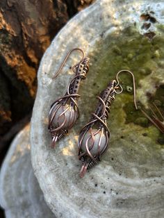 Step into a realm of mystique with these Elven style earrings. The pair feature milky white iridescent resin gems encased in elegant copper settings. Each piece is hand made with care and meticulously crafted to provide a certain uniqueness. Perfect for someone who wants to express their inner enchantress. These earrings are truly an ethereal statement.  Features: white resin gemstones Materials: copper wire, resin, copper ear wire  Style: elven inspired White Copper Earrings As Gift, White Spiritual Teardrop Earrings, White Wire Wrapped Copper Wire Jewelry, Artisan White Copper Jewelry, White Moonstone Wire Wrapped Earrings, Elven Style, Resin Gems, Iridescent Resin, Easy Crafts To Sell