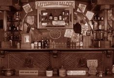 an old fashioned bar with lots of bottles on it