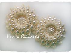 the video shows how to make beaded flower hair clips with pearls and beads on them