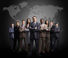 a group of business people standing in front of a world map with their arms crossed