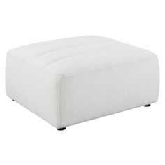 a white ottoman sitting on top of a wooden table