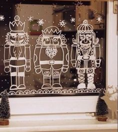 an image of two nutcrackers etched in frosting on a window sill