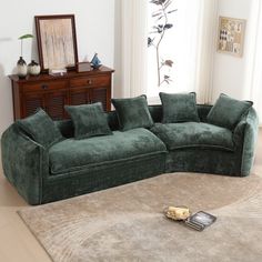 a green couch sitting on top of a rug in a living room