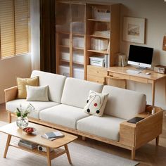 a living room with a couch, coffee table and bookshelf in the corner